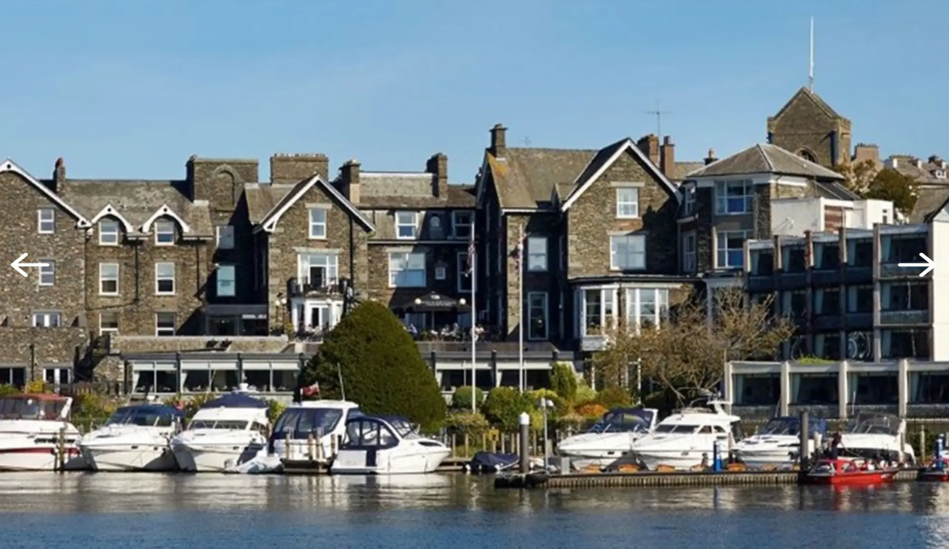 The Old England Hotel on the shores of Lake Windermere with boats in the marina