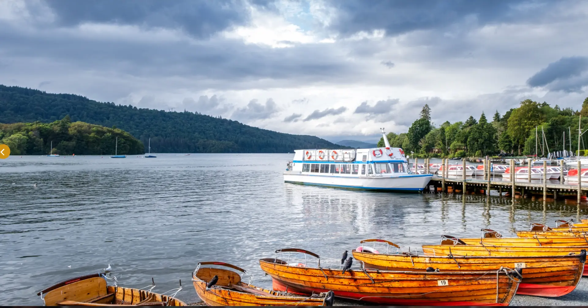 Wooden rowing boats and a lake steamer at Bowness-on-Windermere